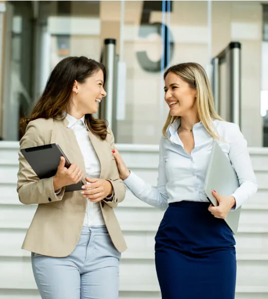 Two professionals discussing work in a bright office