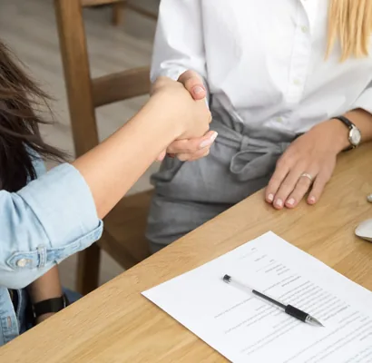 Employment paperwork and business handshake